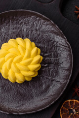 Round sweet tart of yellow color with citrus and passion fruit flavor