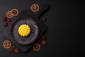 Round sweet tart of yellow color with citrus and passion fruit flavor