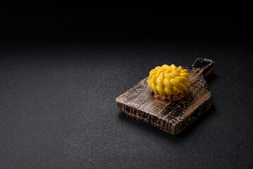 Round sweet tart of yellow color with citrus and passion fruit flavor