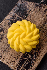 Round sweet tart of yellow color with citrus and passion fruit flavor