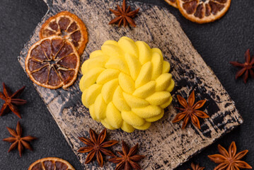 Round sweet tart of yellow color with citrus and passion fruit flavor