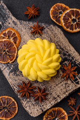 Round sweet tart of yellow color with citrus and passion fruit flavor