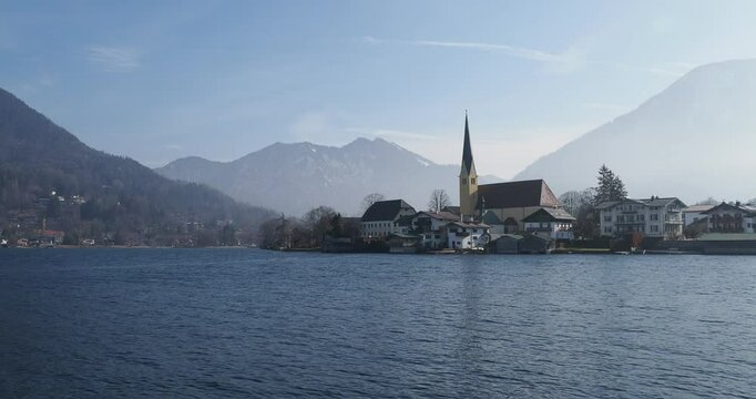 Village of Rottach-Egern and its bell tower on the southern shore of Lake Tegernsee, surrounded by the Bodenschneid and the Wallberg mountains