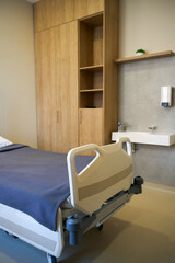 Empty hospital bed with blue sheets