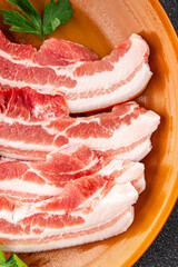 Bacon slices pork meat fresh delicious gourmet food background on the table rustic food top view...