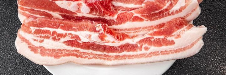 Bacon slices pork meat fresh delicious gourmet food background on the table rustic food top view copy space