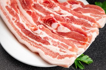 Bacon slices pork meat fresh delicious gourmet food background on the table rustic food top view copy space