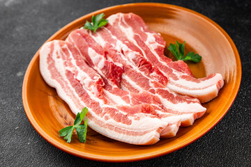 Bacon slices pork meat fresh delicious gourmet food background on the table rustic food top view copy space