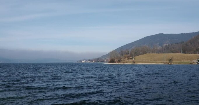Lake Tegernsee along the Eastern shore. Hiil of Tegernsee-Point, Paraplui and beach followed by the Castle and the Brewery looking to the north
