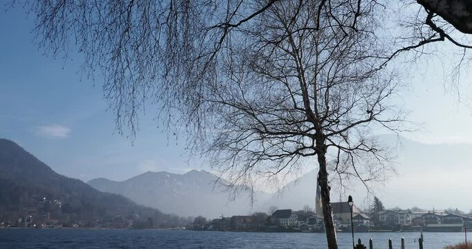 Landscape of Bavarian Alps - Rottach-Egern in the morning mist on the shore of Lake Tegernsee at the foot of Bodenschneid and Wallberg massifs
