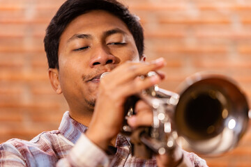 Close-up of a passionate trumpet player immersed in music. Lifestyle.