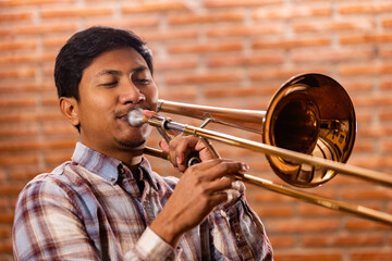 Close-up of a musician playing the trombone with passion. Lifestyle.
