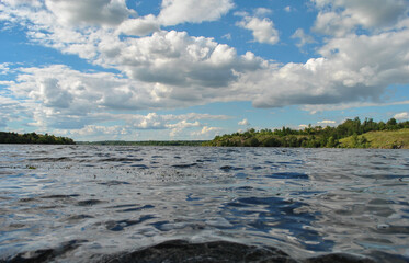 beautiful landscape with a river and sky with clouds. sky with clouds above the river surface