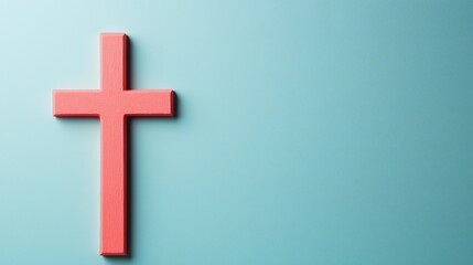 Obraz premium Easter Holiday, Easter Concept, Coral Pink Wooden Cross on Light Blue Background Minimalist Christian Religious Symbol