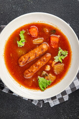 Tomato soup with sausages fresh tasty food dish delicious gourmet food background on the table rustic food top view copy space