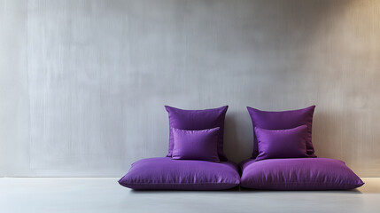 Striking violet pillows artfully arranged against a blank wall for chic modern interior stock photography