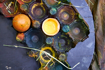 colored dark pallet with eggs for Easter stands on a black board on a table, top view