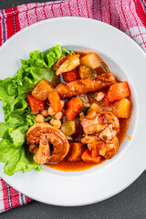 Ragout meat, sausages, vegetables stew dish fresh tasty food delicious gourmet food background on the table rustic food top view copy space