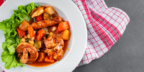 Ragout meat, sausages, vegetables stew dish fresh tasty food delicious gourmet food background on the table rustic food top view copy space