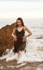 splashes of sea water around a slender girl in the sea