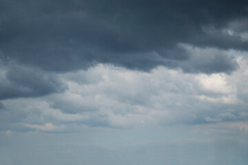 Dramatic stormy sky background. Dark fluffy cloudy sky. Halloween cloudscape background concept.