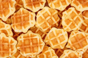 Delicious mini butter waffles with pearl sugar in top view. Waffle background.