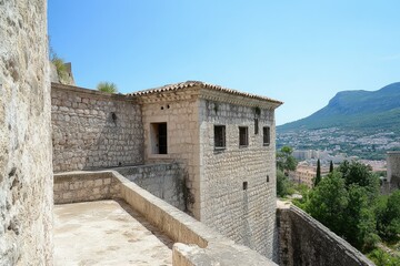 Obraz premium Stone Fortress: Captivating View of an Ancient Prison in the Medieval Castle of Xativa, Europe