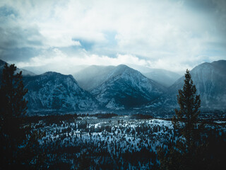 Panoramic view of Colorado's mountains. Colorado's Mountains at sunset. Clouds shroud the mountains in a gentle mist. View of the mountain peaks