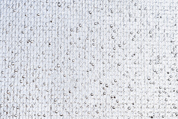 Thin patterned slab of ice against the sky. Abstract background