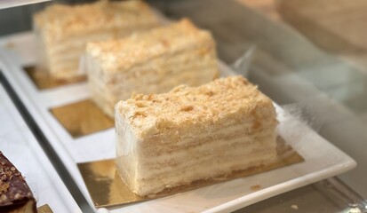 A visually stunning display of elegantly layered cakes, showcasing their smooth texture and inviting indulgence