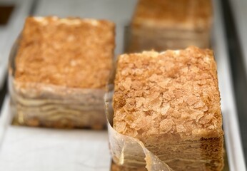 A visually stunning display of elegantly layered cakes, showcasing their smooth texture and inviting indulgence