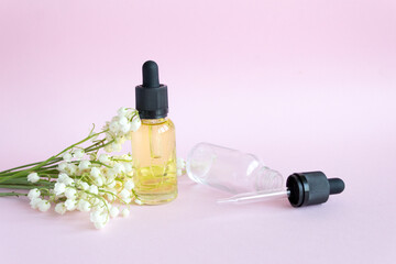 Lily of the valley flower. Dropper glass Bottle makeup. Oil skin care concept