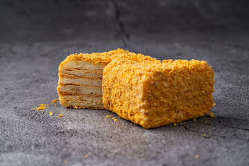 Napoleon Cake Slices with Crumb Coating on a Rustic Stone Background