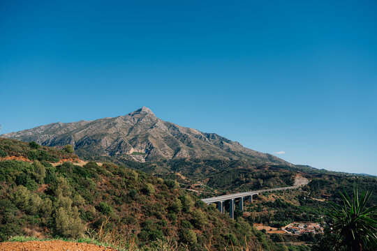 Scenic view of la concha mountain and verdant landscape under clear blue sky