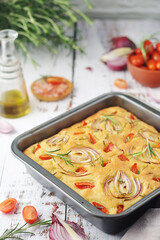 Italian home made bread focaccia with tomatoes and onions