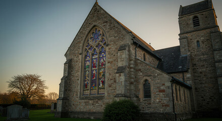 Historic Gothic Church with Stained Glass Windows in Evening Light