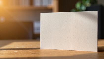 Business card mockup showcasing textures against blurred office backdrop, professionalism