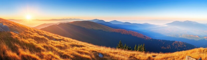 Obraz premium Panoramic view of a mountain landscape with the sun in a blue sky at sunrise