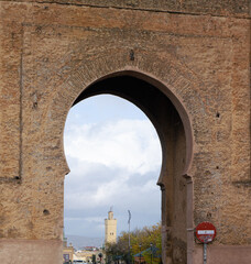 Horseshoe Arch Framing a Minaret in Fez, Morocco: A Timeless View