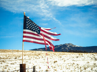 Flag of America Fluttering in the wind on Independence Day. USA flag in the Colorado mountains in winter