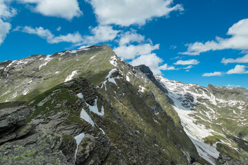 Jagged mountain peaks in remote High Tauern, Austrian Alps. Patches of snow cling to slopes of...