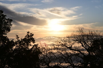 Obraz premium beautiful sunrise in the mountains over the fog and clouds