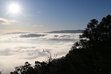 beautiful sunrise in the mountains over the fog and clouds