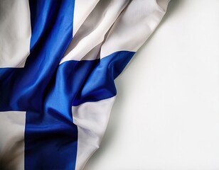 Fototapeta premium Finnish flag displayed on a textured surface with folds and drapes in blue and white