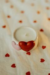 decorative candle with hearts is burning