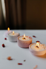 A set of handmade candles decorated with dried flowers. Home aesthetics