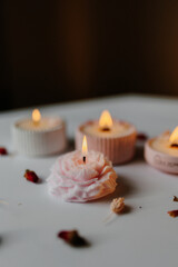 A set of handmade candles decorated with dried flowers. Home aesthetics