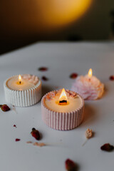 A set of handmade candles decorated with dried flowers. Home aesthetics