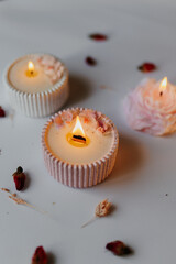A set of handmade candles decorated with dried flowers. Home aesthetics