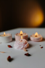 A set of handmade candles decorated with dried flowers. Home aesthetics